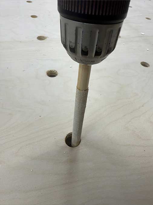 Close-up of a clean, evenly sanded hole after using the dowel trick