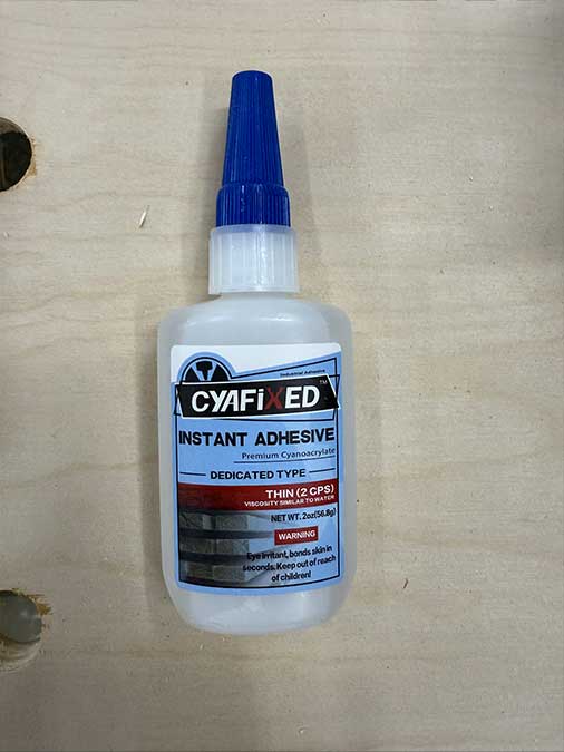 Glue bottle out of the package, ready to apply to the sanding dowel